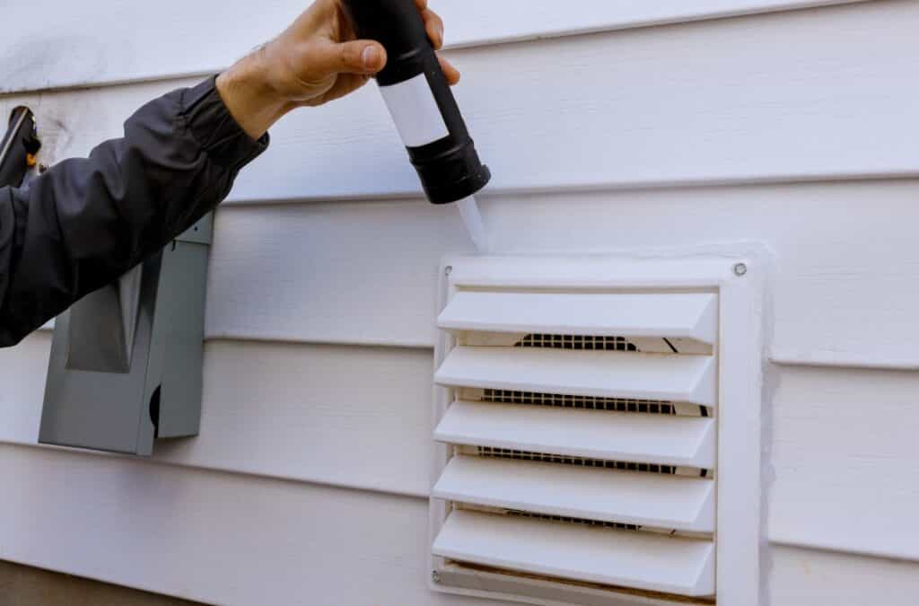 Specialist analyzing insulation and ventilation systems as part of Ventilation Assessment Services for energy savings.
